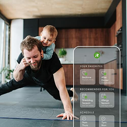Father doing yoga with child on his back in a modern kitchen.