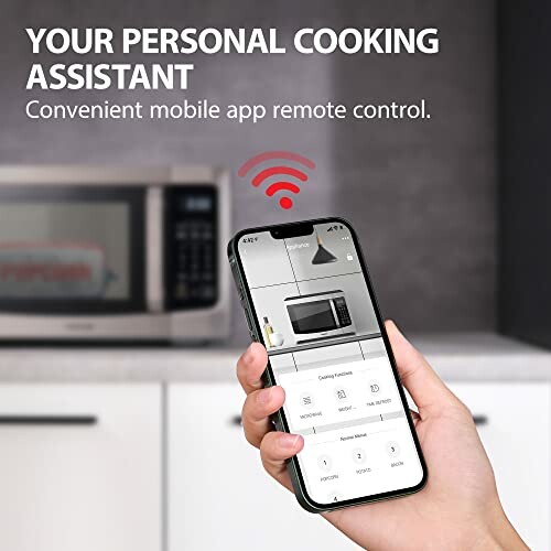 Hand holding smartphone with app to control microwave remotely.